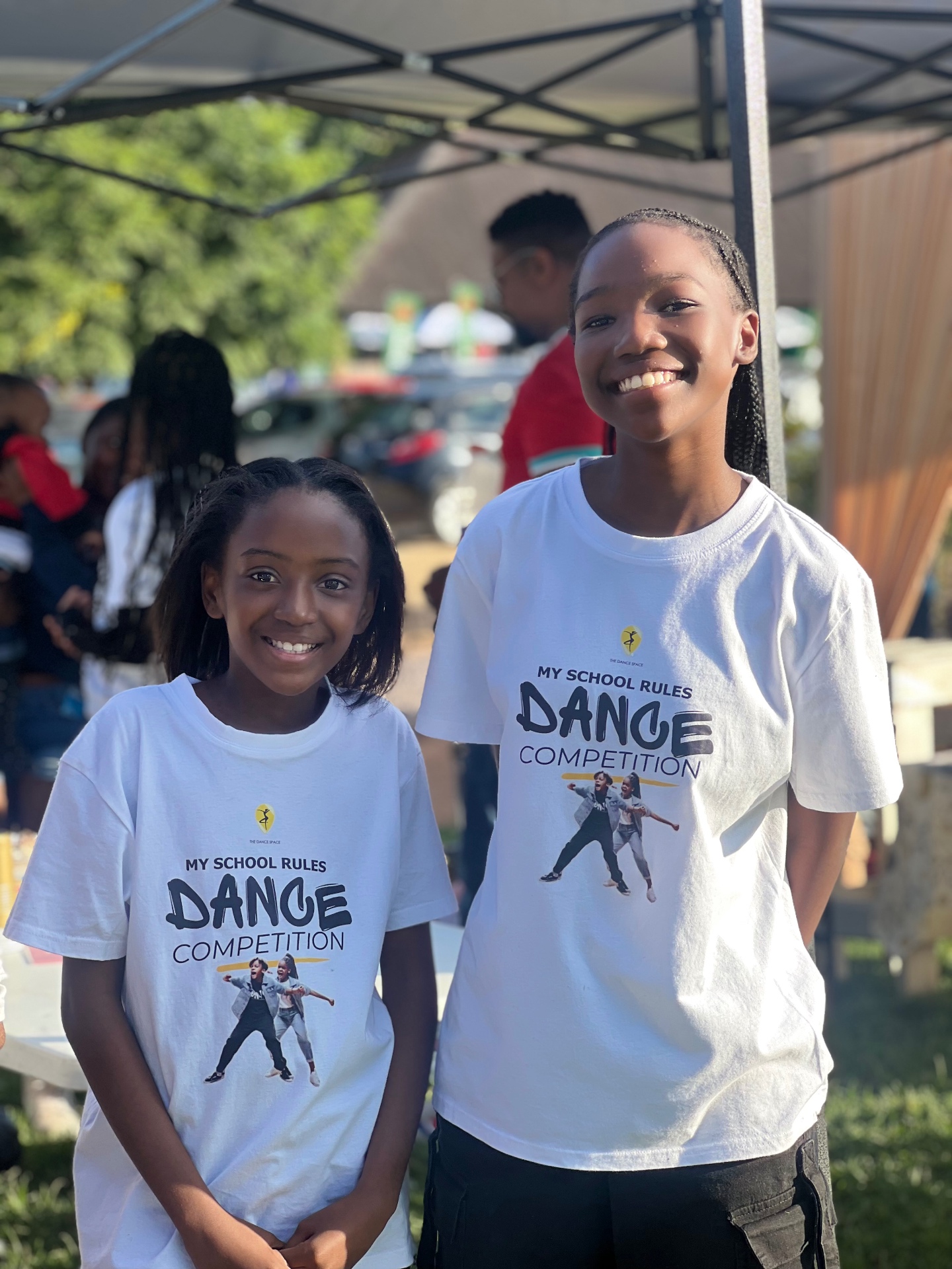 Two students smiling in My School Rules dance competition T-shirts