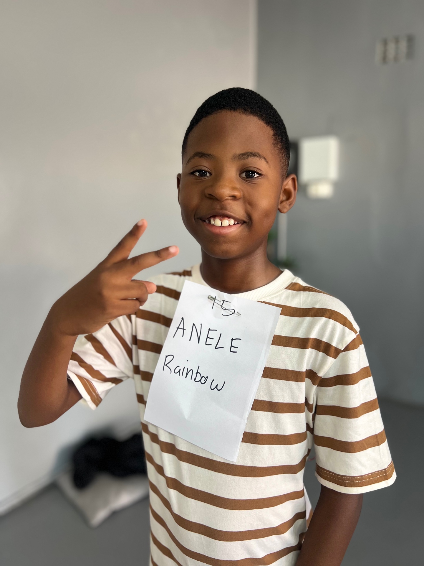A student from the Rainbow school programme posing for the camera