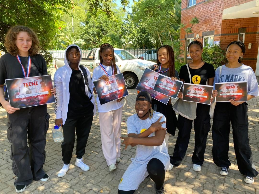 Students celebrating with certificates after a school programme